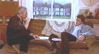 Michael Ball as Purcell, speaks directly to Charles (Simon Callow) in his 1960s apartment.