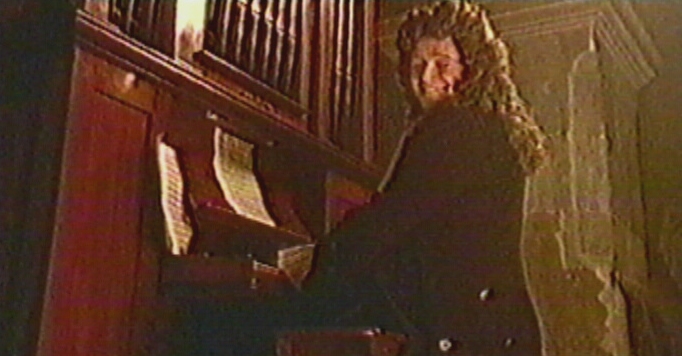 Harry plays the organ whilst enjoying proceedings below.